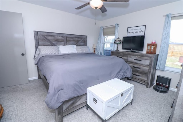 bedroom featuring light colored carpet and ceiling fan