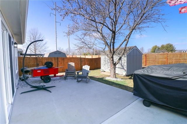 view of patio with area for grilling and a shed