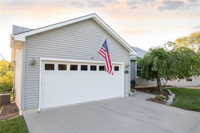 view of front of property with a garage and central air condition unit