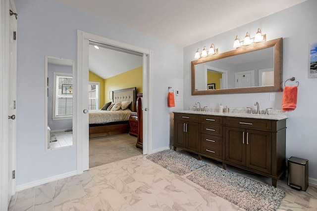 bathroom featuring vanity and vaulted ceiling