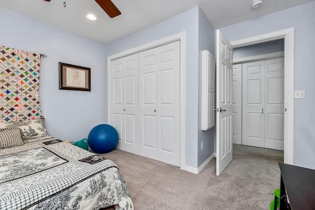 carpeted bedroom with ceiling fan and a closet