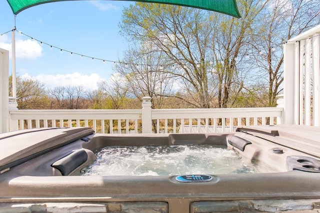 wooden terrace featuring a hot tub