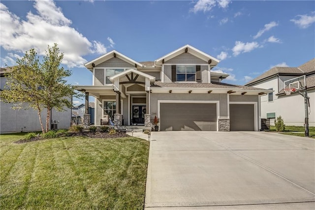 view of front of property featuring a garage, a front yard, and covered porch