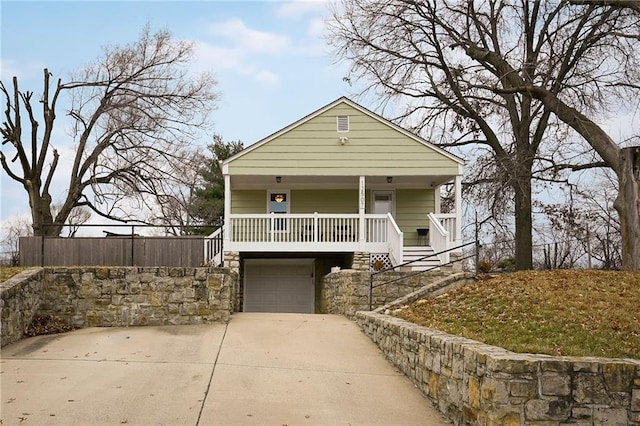 bungalow featuring a garage and covered porch