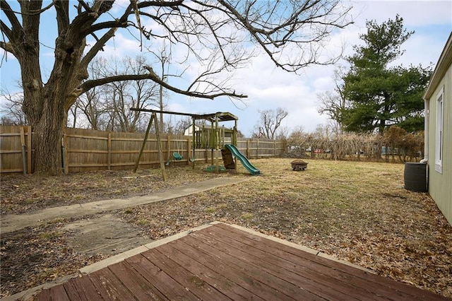 exterior space featuring a wooden deck and a fire pit