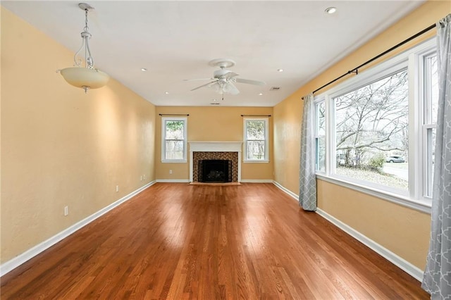 unfurnished living room with hardwood / wood-style floors and ceiling fan