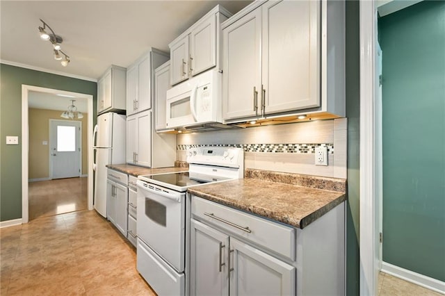 kitchen with tasteful backsplash, white appliances, white cabinetry, and light tile patterned flooring