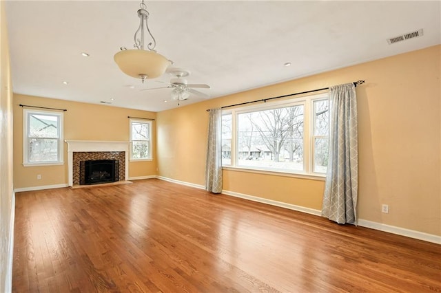 unfurnished living room with hardwood / wood-style floors and ceiling fan