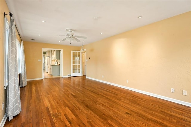 spare room with hardwood / wood-style flooring and ceiling fan