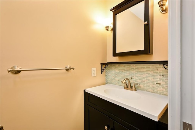 bathroom with tasteful backsplash and vanity