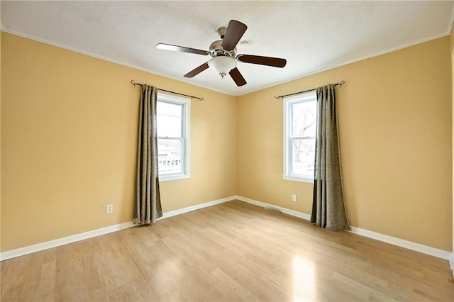 unfurnished room with crown molding, ceiling fan, and light wood-type flooring