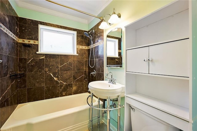 full bathroom with sink, ornamental molding, toilet, and tiled shower / bath