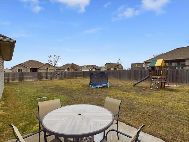 view of yard with a trampoline, a patio area, and a playground