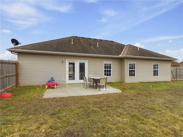 back of house with a yard and a patio area