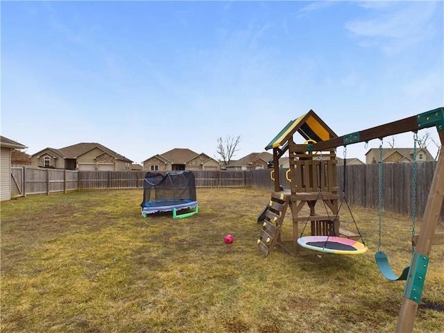 view of jungle gym featuring a yard and a trampoline