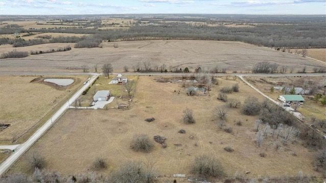 birds eye view of property with a rural view