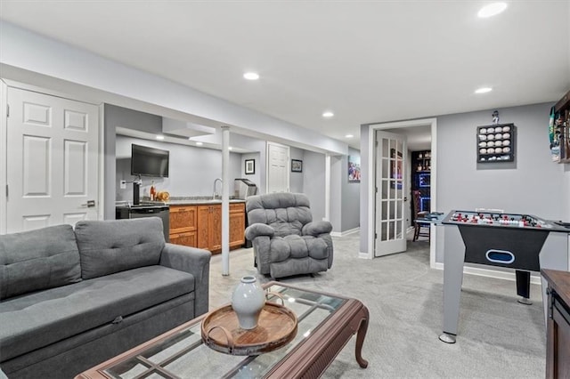 living room featuring sink and light carpet