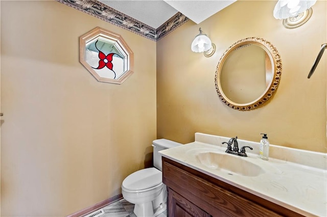 bathroom with vanity and toilet