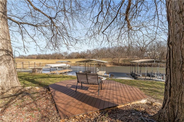 wooden deck with a gazebo, a water view, and a boat dock