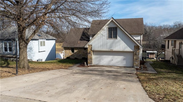 view of front of home with a garage and central air condition unit