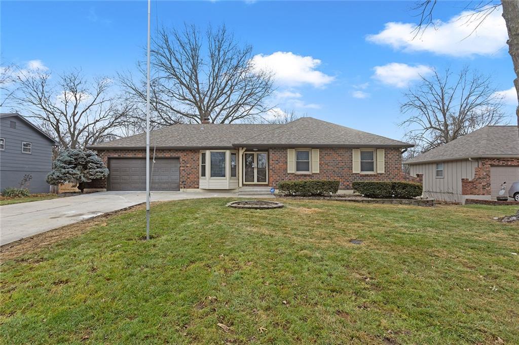 ranch-style home with a garage and a front yard