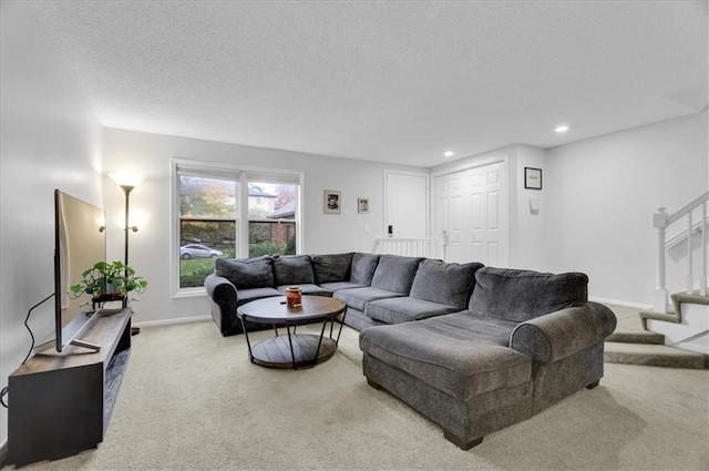 living room featuring carpet flooring and a textured ceiling