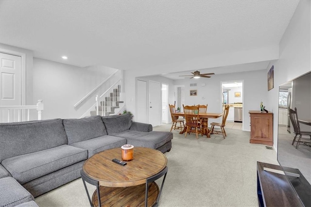 carpeted living room with ceiling fan