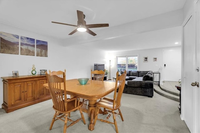 dining room featuring light carpet and ceiling fan