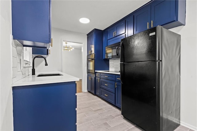 kitchen featuring sink, blue cabinetry, and black appliances