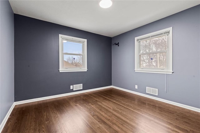 spare room featuring wood-type flooring