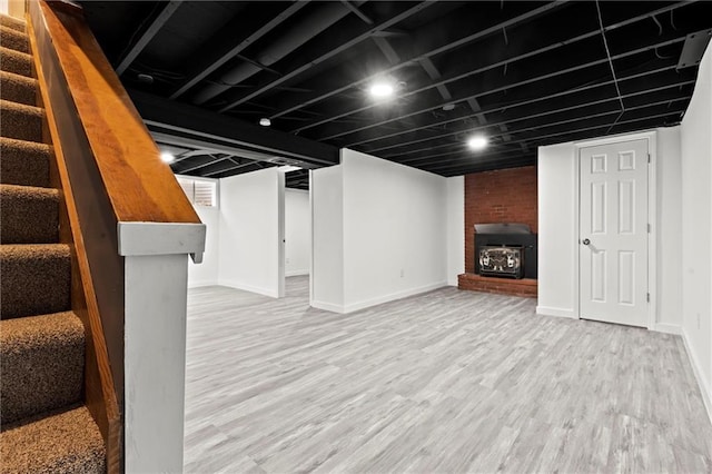 basement with light hardwood / wood-style flooring