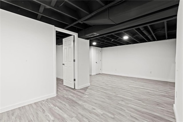 basement featuring light hardwood / wood-style flooring