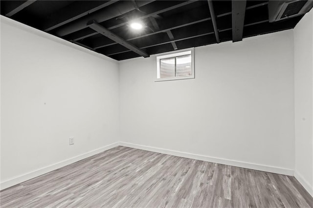 basement with light hardwood / wood-style floors