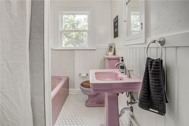 bathroom with tile patterned flooring and a bathtub