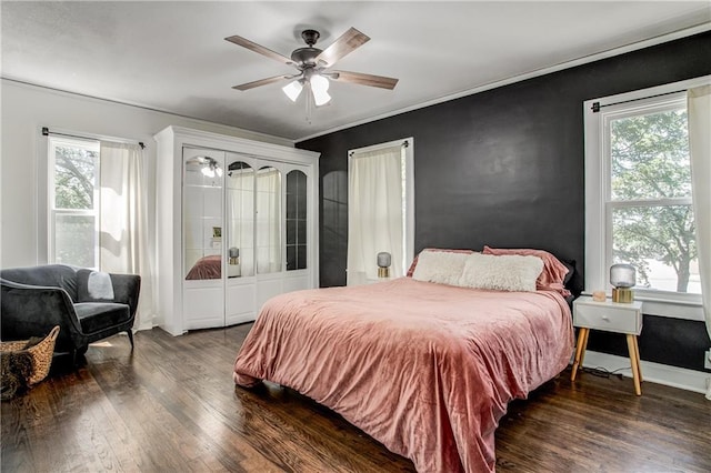 bedroom featuring ceiling fan, ornamental molding, and dark hardwood / wood-style floors