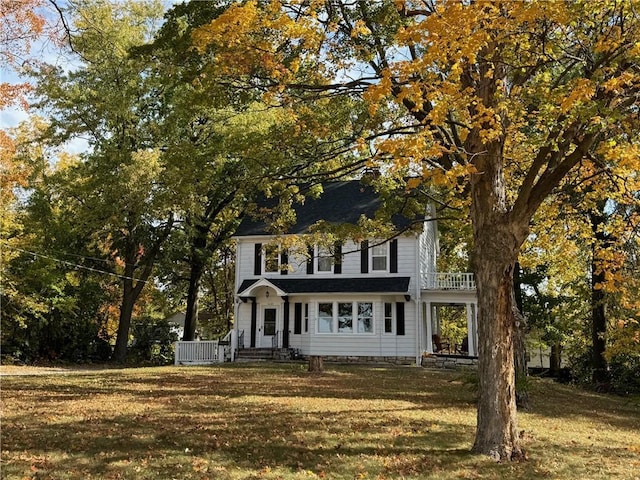 colonial house featuring a front lawn