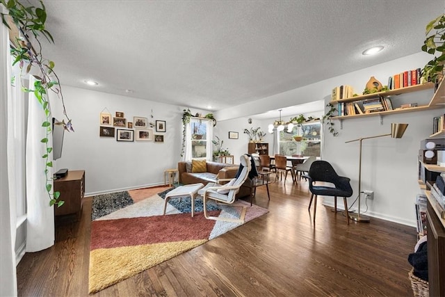 living room with dark hardwood / wood-style flooring and a textured ceiling