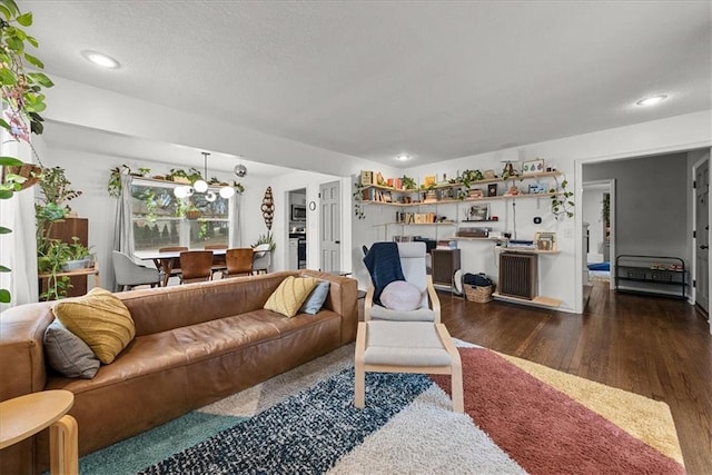 living room featuring a chandelier and dark hardwood / wood-style flooring