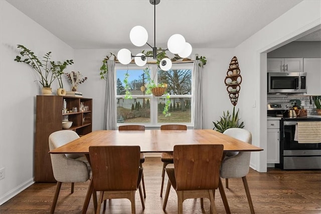 dining space featuring dark hardwood / wood-style floors and a chandelier