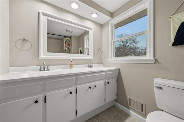 bathroom with vanity and toilet