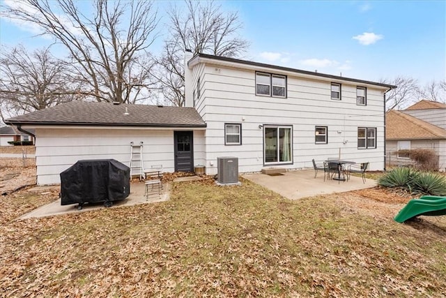 back of property featuring central AC unit, a yard, and a patio