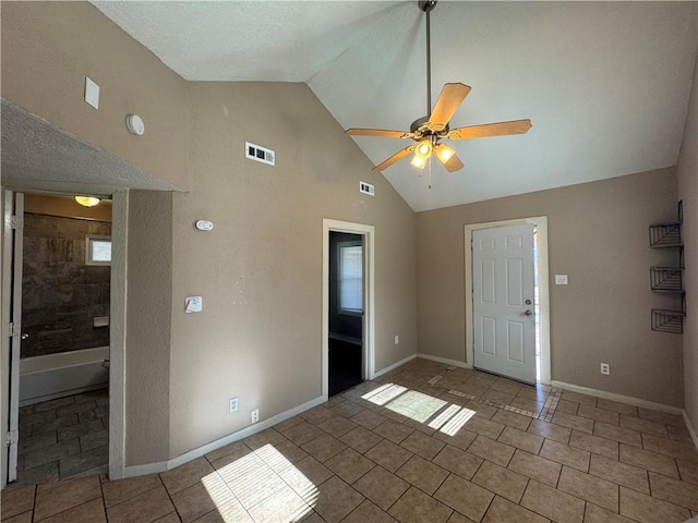 tiled spare room with high vaulted ceiling and ceiling fan