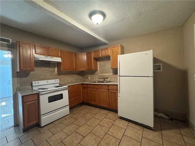 kitchen with sink, light tile patterned floors, white appliances, and decorative backsplash