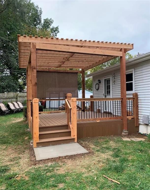 wooden terrace featuring a pergola and a lawn