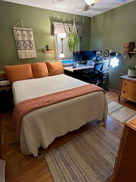 bedroom with ceiling fan and wood-type flooring