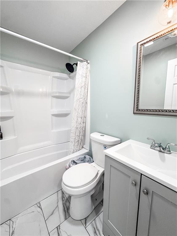 full bathroom with vanity, toilet, and shower / bath combo with shower curtain