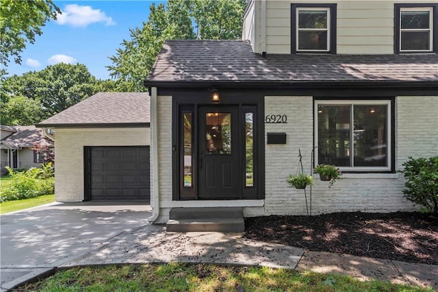 doorway to property with a garage