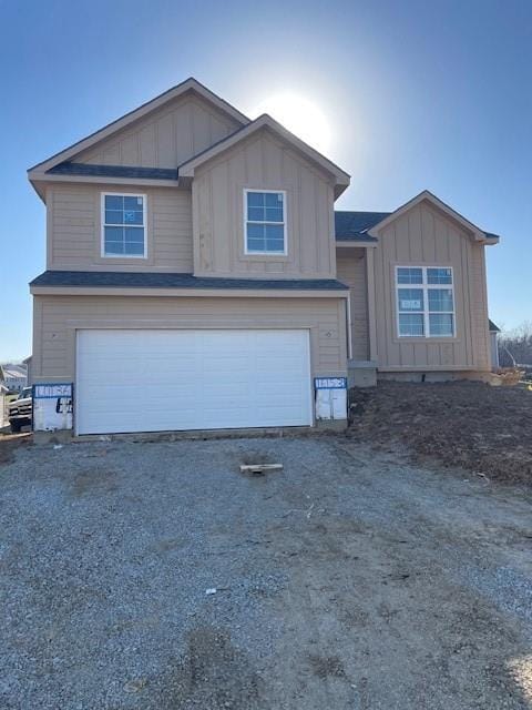 view of front facade featuring a garage, driveway, and board and batten siding