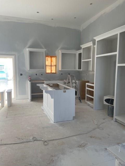 kitchen featuring a healthy amount of sunlight, a kitchen island, and crown molding