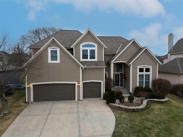 front facade featuring a garage and a front yard